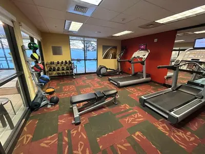 a gym with several cardio machines in a room at Courtyard by Marriott Harrisburg West Mechanicsburg in Mechanicsburg