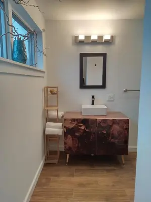 a bathroom with a sink and a mirror at Black Top Retreat in Wyalusing