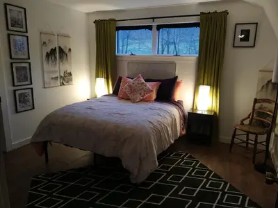 a bedroom with a large bed with a window at Black Top Retreat in Wyalusing