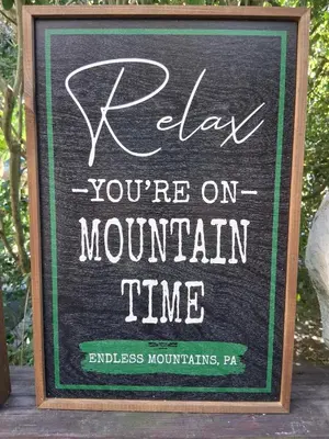 a sign that says relax youre on mountain time at Black Top Retreat in Wyalusing