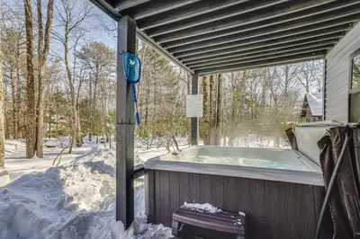 a jacuzzi tub on a house in the snow at Poconos Ski Base with Hot Tub and Game Room! in Lake Harmony