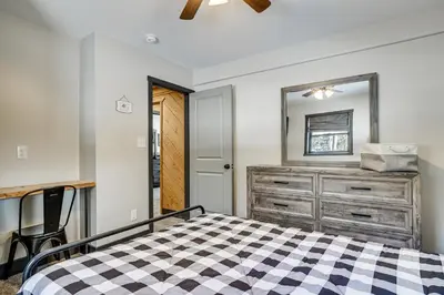 a bedroom with a bed and a dresser and a mirror at Poconos Ski Base with Hot Tub and Game Room! in Lake Harmony