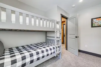 a bedroom with a bunk bed and a staircase at Poconos Ski Base with Hot Tub and Game Room! in Lake Harmony