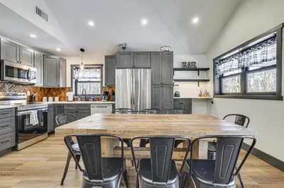 a kitchen with a large wooden table and chairs at Poconos Ski Base with Hot Tub and Game Room! in Lake Harmony