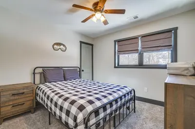 a bedroom with a bed and a ceiling fan at Poconos Ski Base with Hot Tub and Game Room! in Lake Harmony