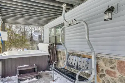 a hose is attached to the side of a house at Poconos Ski Base with Hot Tub and Game Room! in Lake Harmony