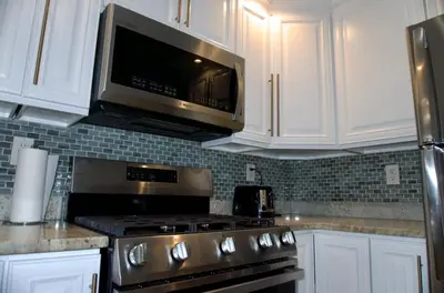 a kitchen with a stove and a microwave at New York Private room 30 in West New York