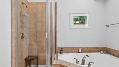 a bathroom with a bath tub and a shower at Crestline Retreat by AvantStay Luxury Mountain Condo with Hot Tub BBQ Game Room Steps to Big Boulder in Lake Harmony