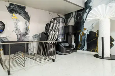 a kitchen with a counter and a wall with graffiti at Modern 3 Bedroom 7 minutes to Manhattan in Jersey City