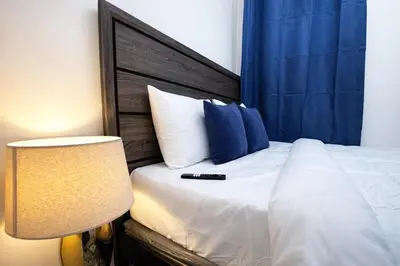 a bedroom with a bed with a black remote control on it at JC Central Stylish Stay Near Manhattan 1A in Jersey City