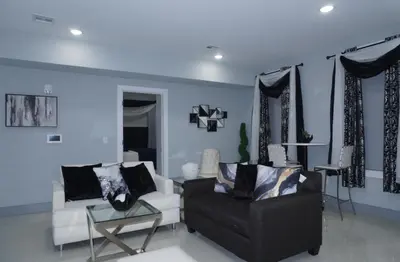 a living room with a couch and a chair at Big apple room 35 in West New York