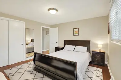 a bedroom with a large bed and a mirror at Cozy 1 bedroom house in Lititz in Lititz