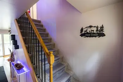 a staircase with a sign that reads home trails at Deer Trails Retreat -Pocono Getaway Near Kalahari in Pocono Summit
