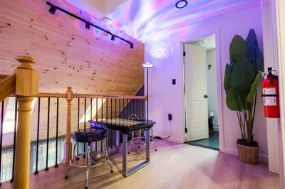 a room with a wooden wall with a table and stools at Deer Trails Retreat -Pocono Getaway Near Kalahari in Pocono Summit