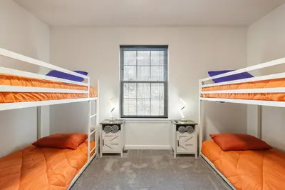 two bunk beds in a room with a window at The Aerie House In Tobyhanna in Tobyhanna