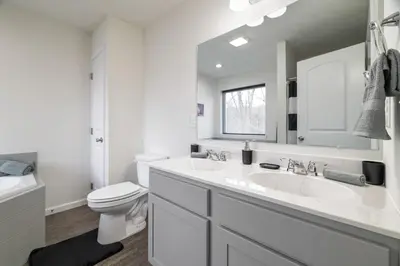 a white bathroom with a sink and a toilet at The Aerie House In Tobyhanna in Tobyhanna