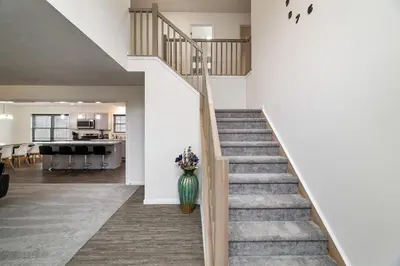 a staircase in a home with a vase of flowers at The Aerie House In Tobyhanna in Tobyhanna