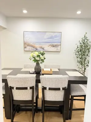 a dining room with a black table and chairs at 35 to NYC - Netflix - 2Beds -1BR - FIFA 2026 in Passaic