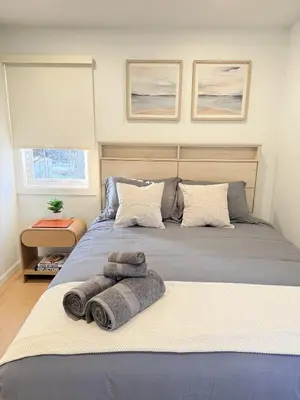 a bedroom with a large bed with towels on it at 35 to NYC - Netflix - 2Beds -1BR - FIFA 2026 in Passaic