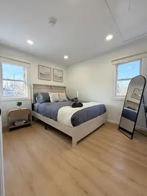 a bedroom with a large bed and two windows at 35 to NYC - Netflix - 2Beds -1BR - FIFA 2026 in Passaic