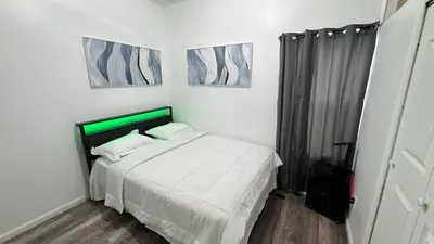 a bedroom with a bed and two pictures on the wall at Style and tranquility within walking distance of everything
