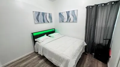 a bedroom with a bed and two pictures on the wall at Style and tranquility within walking distance of everything