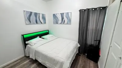 a bedroom with a bed and two pictures on the wall at Style and tranquility within walking distance of everything