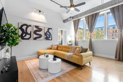 a living room with a couch and a table at 2BR City Getaway - Close to NYC - Prime Location in Hoboken
