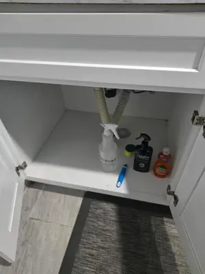 a white cabinet with a shelf under a sink at Newly Renovated Detached Studio apartment in Irvington