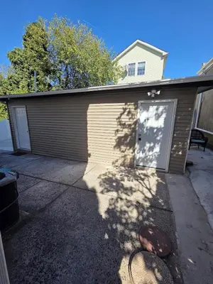 a house with a garage with a door at Newly Renovated Detached Studio apartment in Irvington
