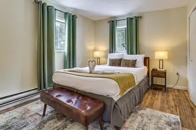 a bedroom with a large bed with green curtains at Steps to Lake! Family Haven with Hot Tub in Poconos in Tobyhanna
