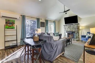 a living room with a couch and a fireplace at Steps to Lake! Family Haven with Hot Tub in Poconos in Tobyhanna