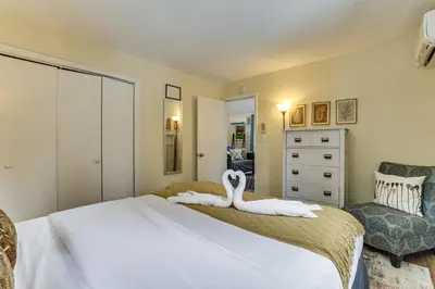 a bedroom with a bed with a swan on it at Steps to Lake! Family Haven with Hot Tub in Poconos in Tobyhanna