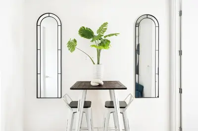 a table with two chairs and a vase with a plant at 48-4FE 2BR Prime Midtown West in New York