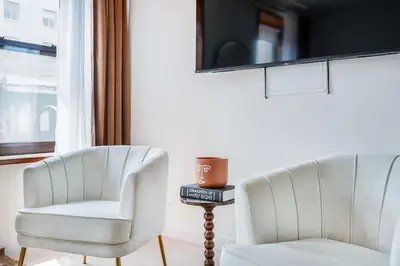 two white chairs sitting next to a window at 319-3A XL New Modern 1BR Union Square WD in Unit in New York
