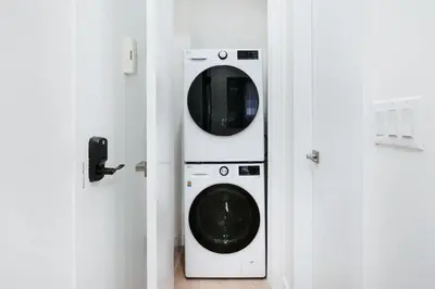 a washer and dryer in a room with two doors at 319-3A XL New Modern 1BR Union Square WD in Unit in New York