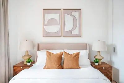 a bedroom with a white bed with two lamps at 319-3A XL New Modern 1BR Union Square WD in Unit in New York