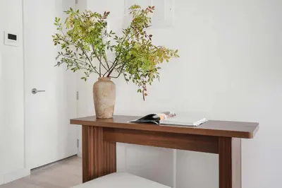 a table with a vase with a plant on it at 317-4B Brand New Modern 1BR Union Square WD in Unit in New York