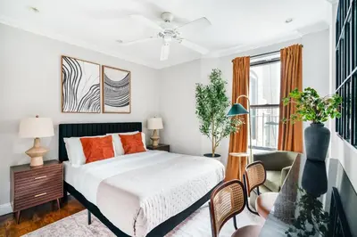 a bedroom with a bed with orange pillows at Mott-9 Prime Soho Cozy New Studio WD in the unit in New York