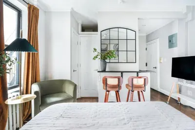 a living room with a bed and two chairs at Mott-9 Prime Soho Cozy New Studio WD in the unit in New York
