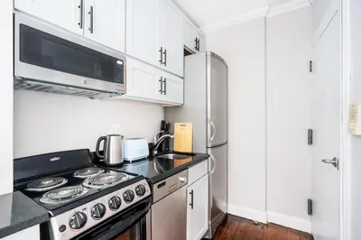 a kitchen with a stove and a microwave at Mott-9 Prime Soho Cozy New Studio WD in the unit in New York