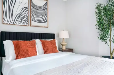 a bedroom with a white bed with orange pillows at Mott-9 Prime Soho Cozy New Studio WD in the unit in New York