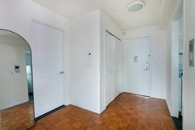 an empty room with white walls and wooden floors at 43-20A Newly furnished 1BR- full service Doorman laundry Gym Business Center in New York