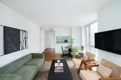 a living room with a couch and a table at 43-20A Newly furnished 1BR- full service Doorman laundry Gym Business Center in New York