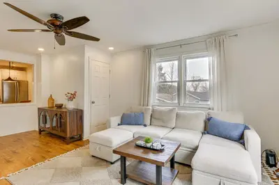 a living room with a couch and a ceiling fan at Walk to Lake Hopatcong Vibrant Home with Deck! in Hopatcong