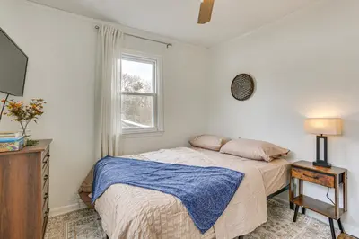 a white bedroom with a bed and a window at Walk to Lake Hopatcong Vibrant Home with Deck! in Hopatcong