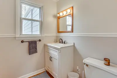 a bathroom with a sink and a mirror and a toilet at Walk to Lake Hopatcong Vibrant Home with Deck! in Hopatcong