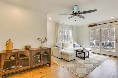 a living room with a couch and a ceiling fan at Walk to Lake Hopatcong Vibrant Home with Deck! in Hopatcong