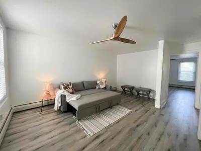 a living room with a couch and a ceiling fan at Chic Phoenixville Retreat With Parking in Phoenixville