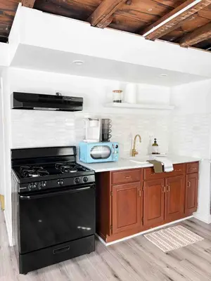 a kitchen with a black stove and a sink at Modern Escape in Phoenixville, 4 Guests, Parking in Phoenixville